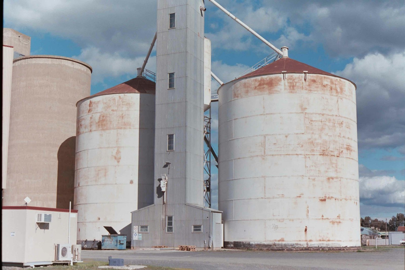 Grain silos and an elevator tower beneath a cloudy sky in Colbinabbin, Australia. Illustrative photograph.